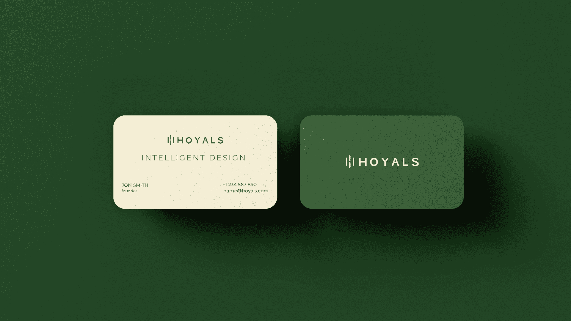 Hoyals business cards in cream and forest green on a green background