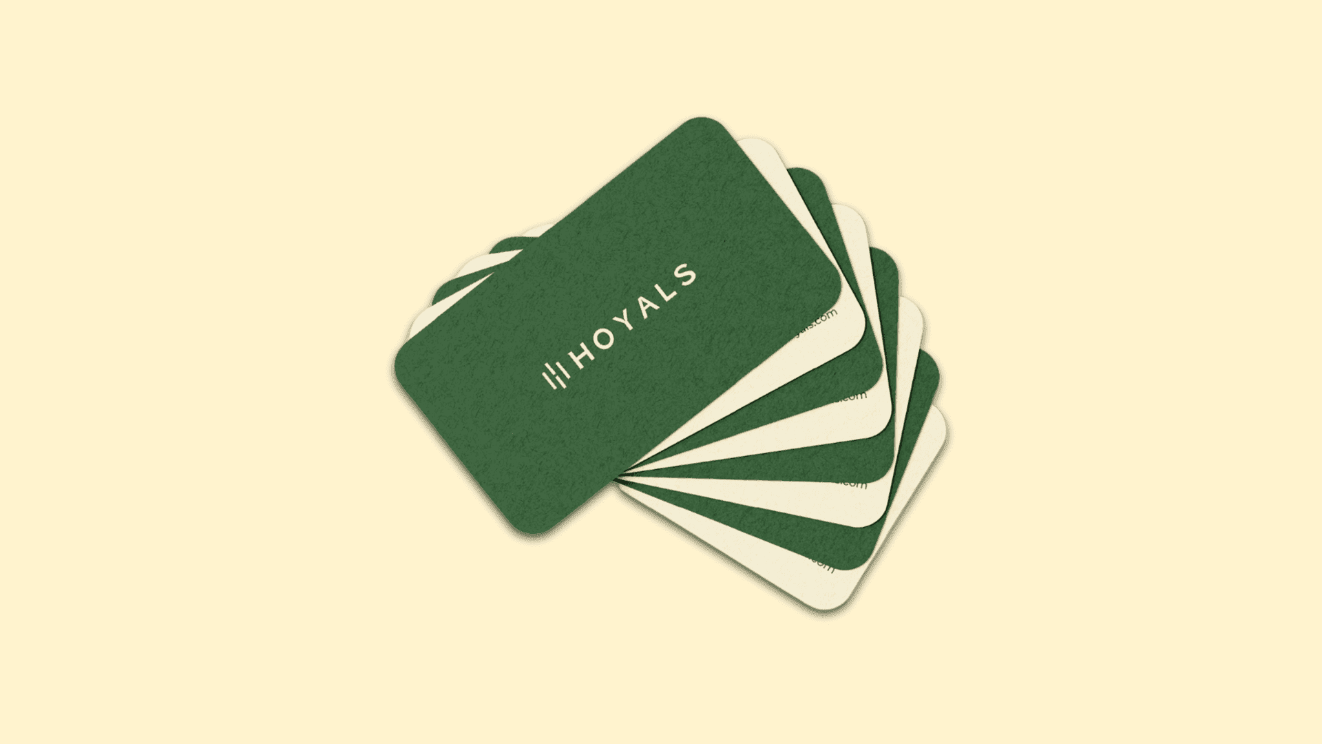 A fanned stack of green and cream Hoyals business cards