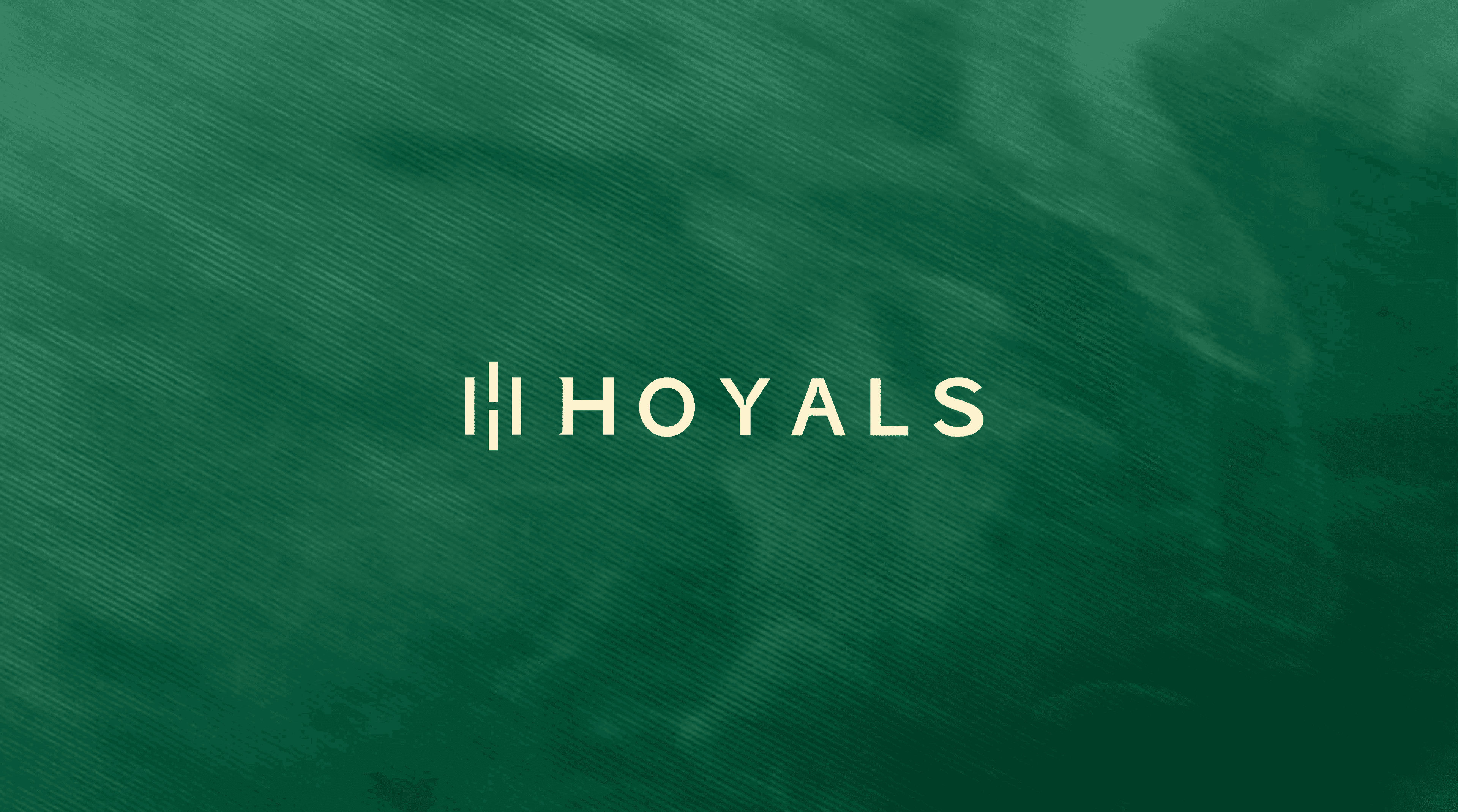 The Hoyals logo in cream on a textured forest green background