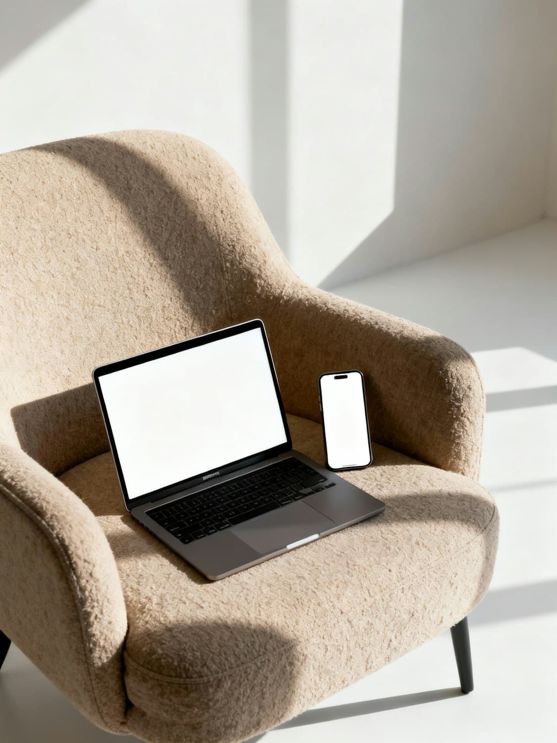 A laptop on a leather sofa in warm afternoon light